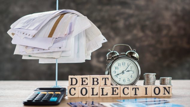 Alarm clock with bill spike and Debt Collection sign, Bounce Back Loans debt concept 