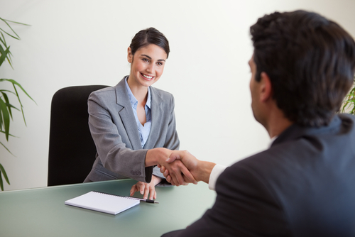  Woman shaking hands with customer, customer retention concept 